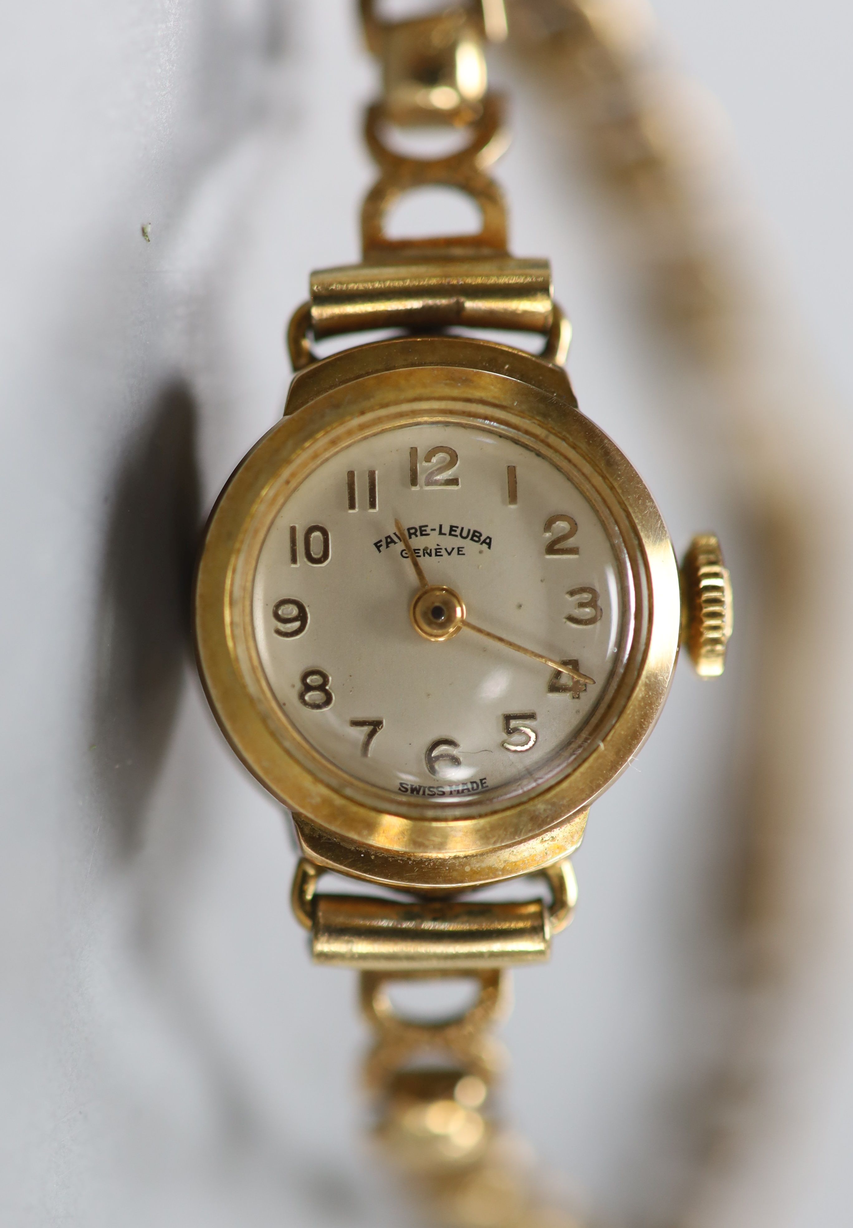 A lady's 9ct god Favre Leuba manual wind wrist watch, on a 9ct gold bracelet
